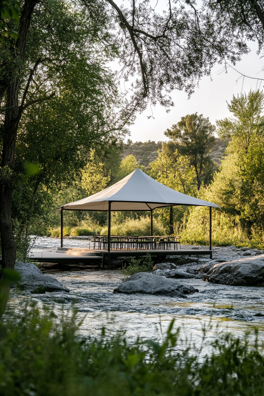 Riverside space. canvas tent gazebo overlooking gently flowing river.