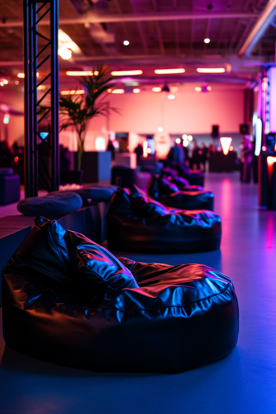 Event support space. Neon lit charging station with black-leather bean bags.